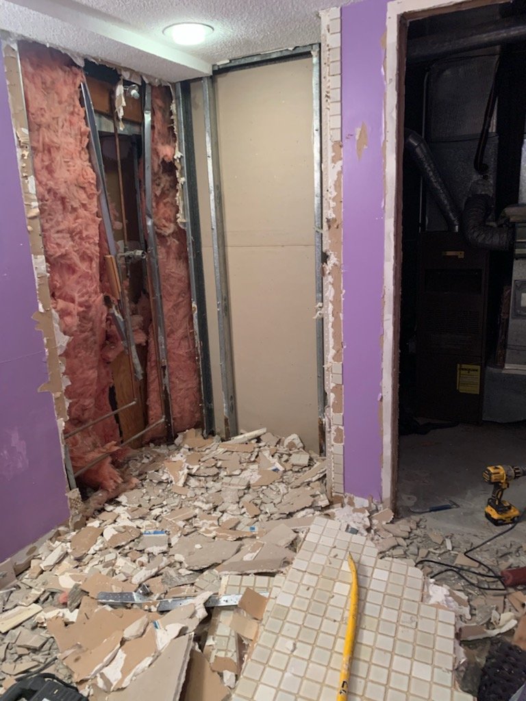 Wall cavity and old finishes opened during bathroom demolition in Boxford Massachusetts