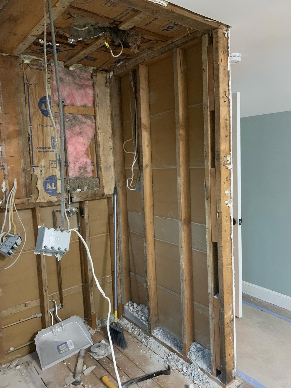 Wall framing and plumbing exposed during a Boxford bathroom rebuild