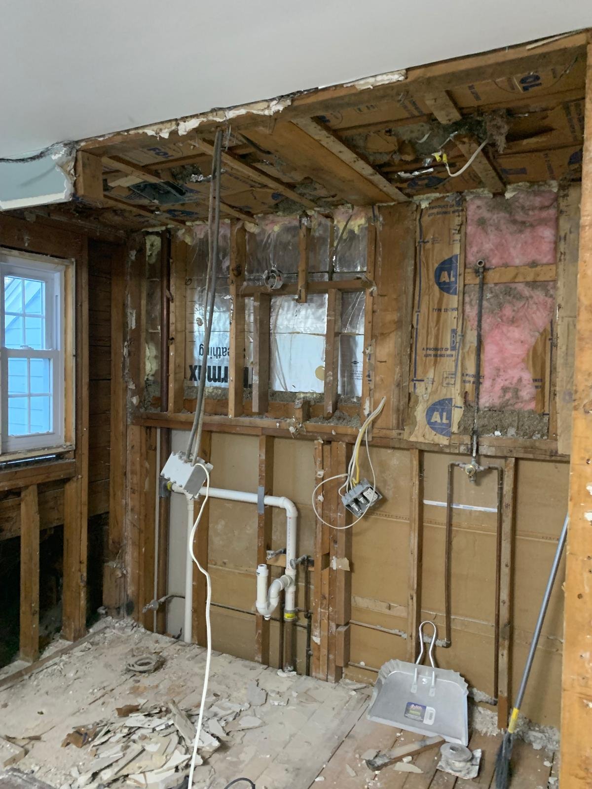 Wide view of the gutted bathroom during reconstruction in Boxford Massachusetts