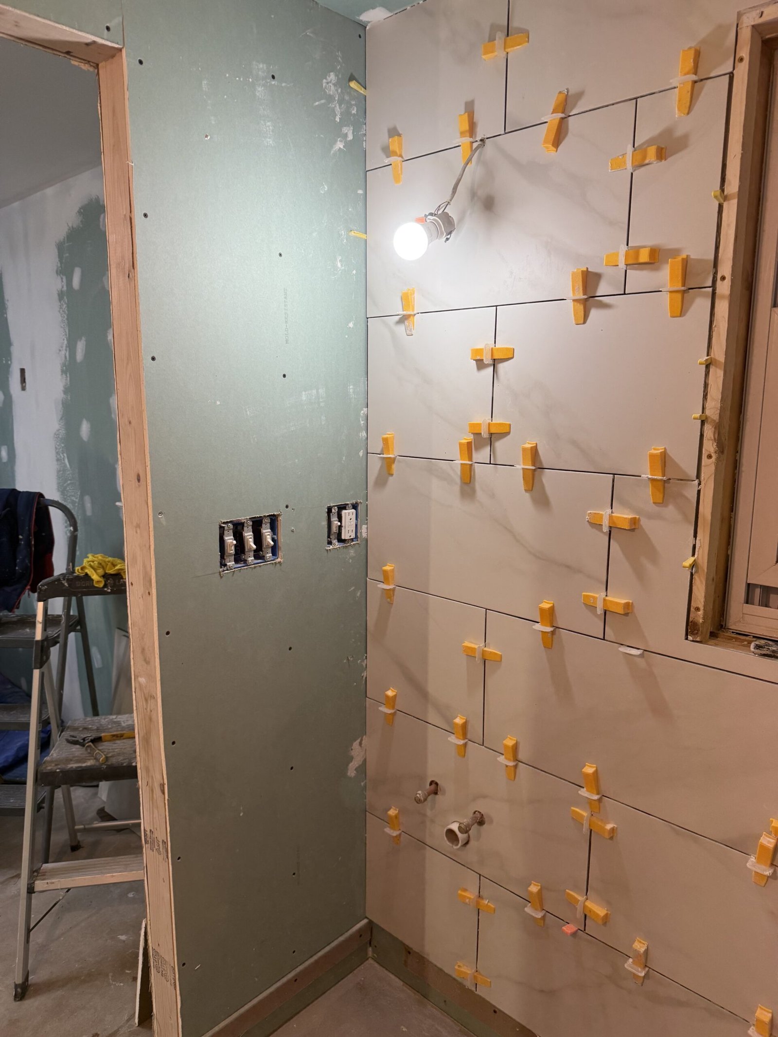 Bathroom tile work advancing around the shower area in Boxford Massachusetts