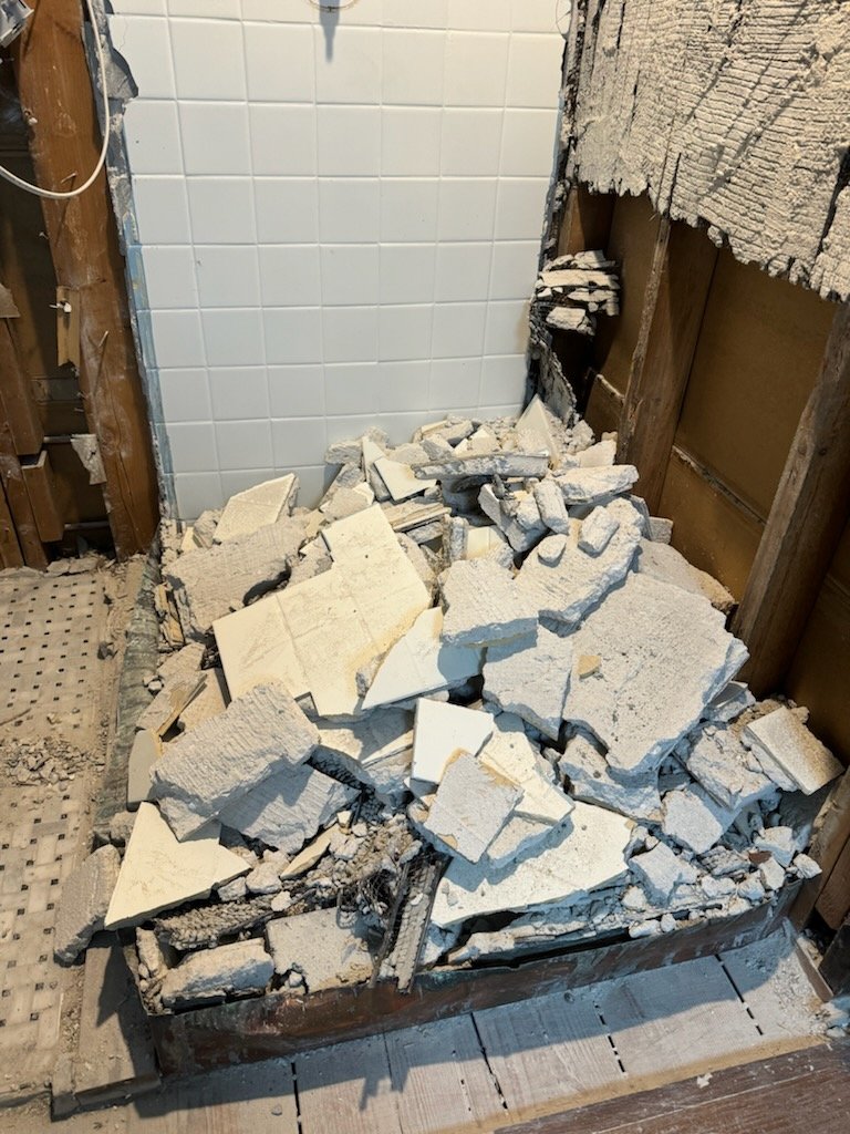 Removed tile and wall materials during bathroom demolition in Boxford Massachusetts