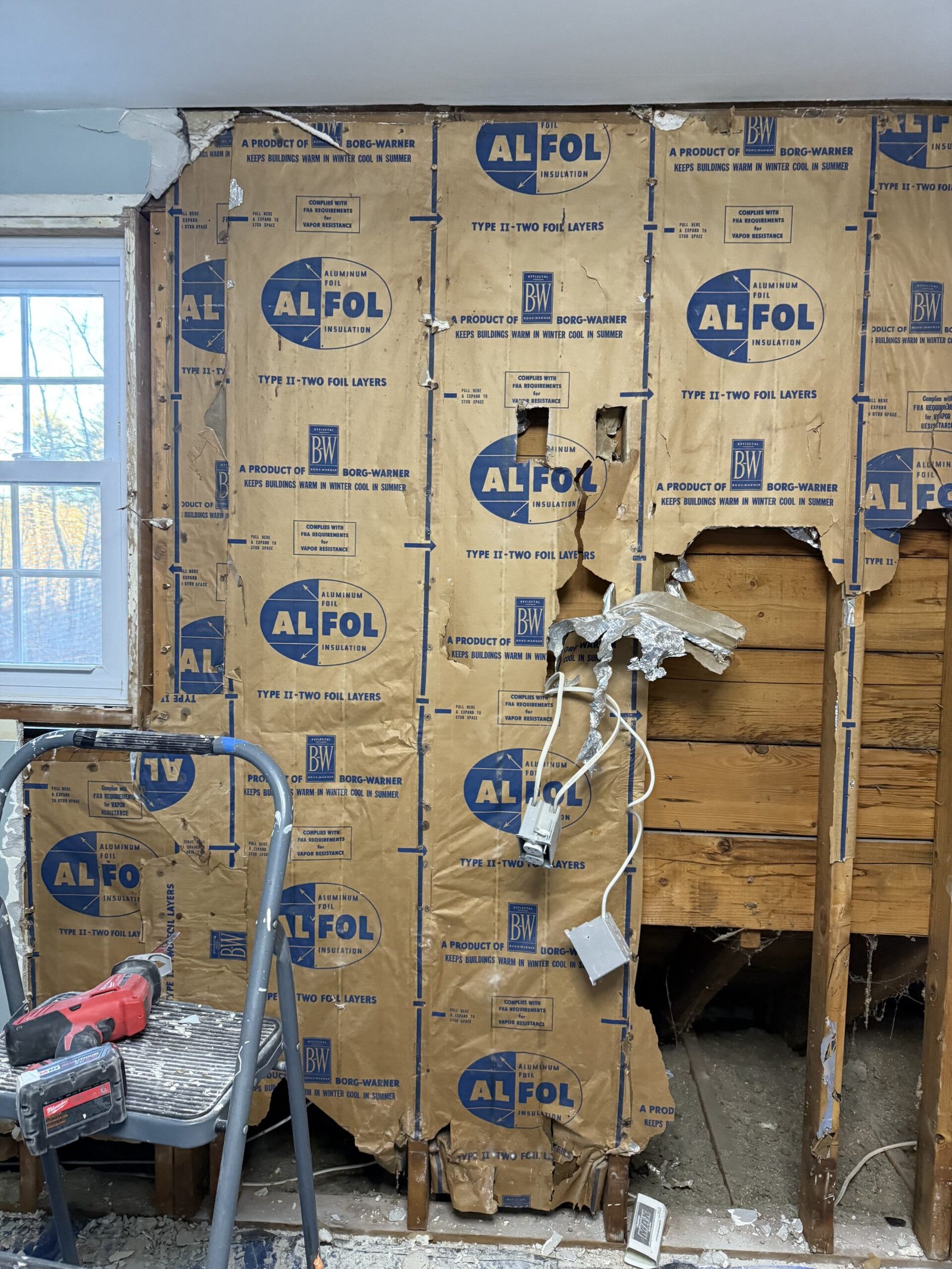 Wall opened for insulation and reconstruction during a Boxford room expansion