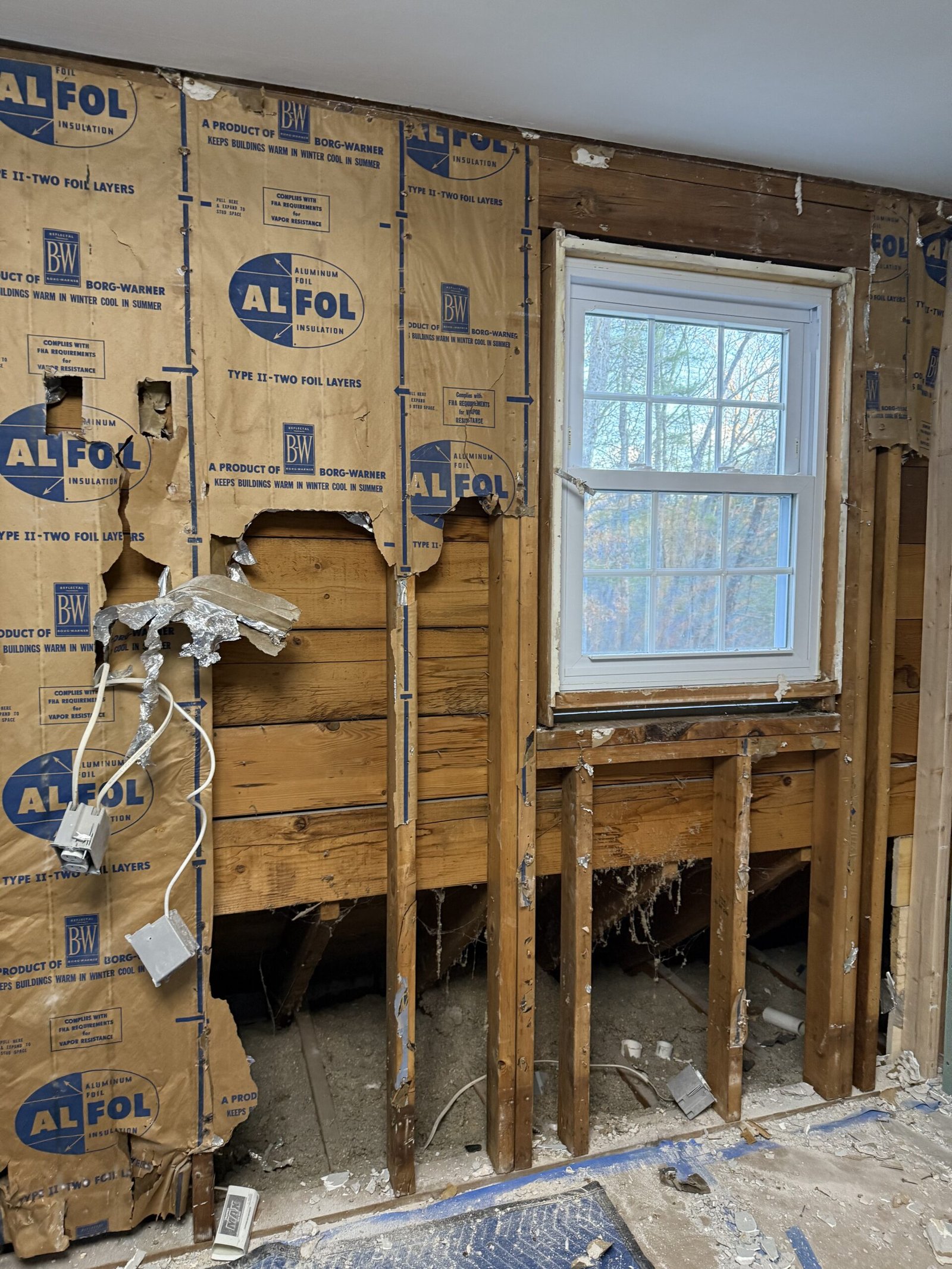 Framing wiring and insulation exposed during interior reconstruction in Boxford Massachusetts