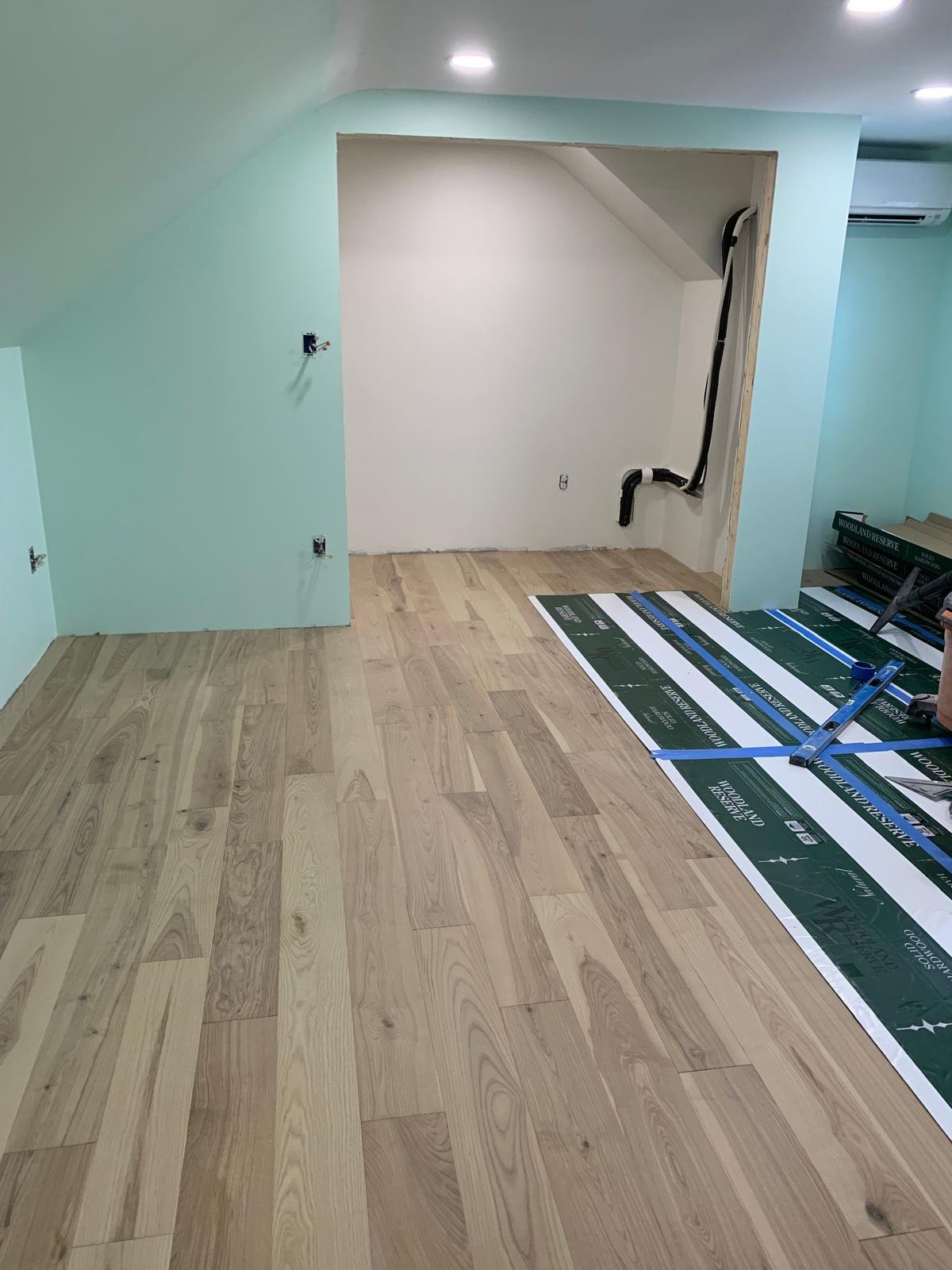 New flooring installation beginning after room reconstruction in Boxford Massachusetts