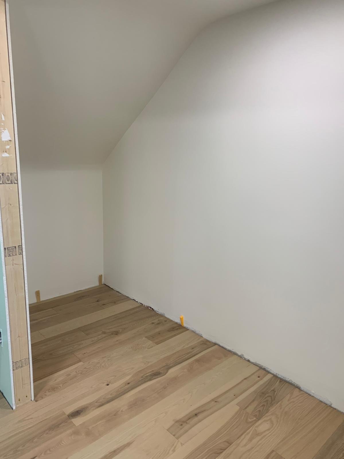 Rebuilt room with finished wall surfaces and new flooring in Boxford Massachusetts