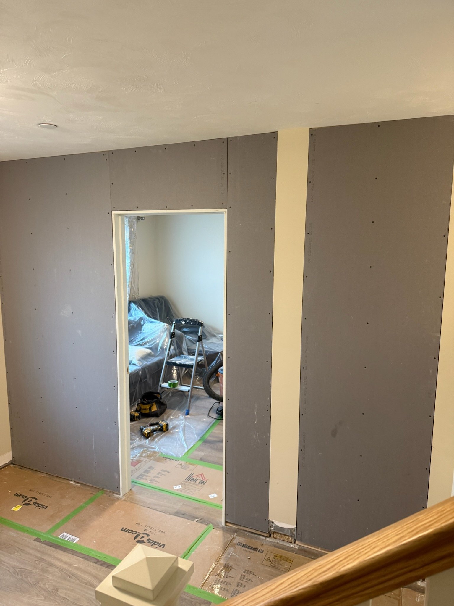 Drywall installed around the new hallway opening during a Bridgewater room conversion