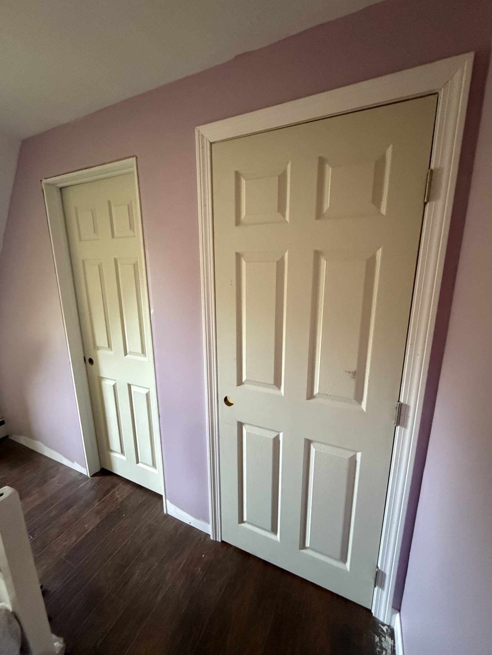 Inside one completed room showing two new paneled doors and finished flooring in Bridgewater Massachusetts