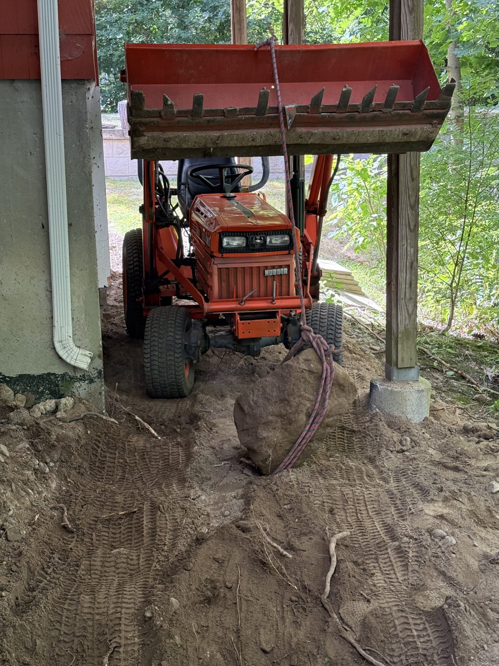 Excavator beginning site excavation for a Dover Massachusetts patio and walkway project