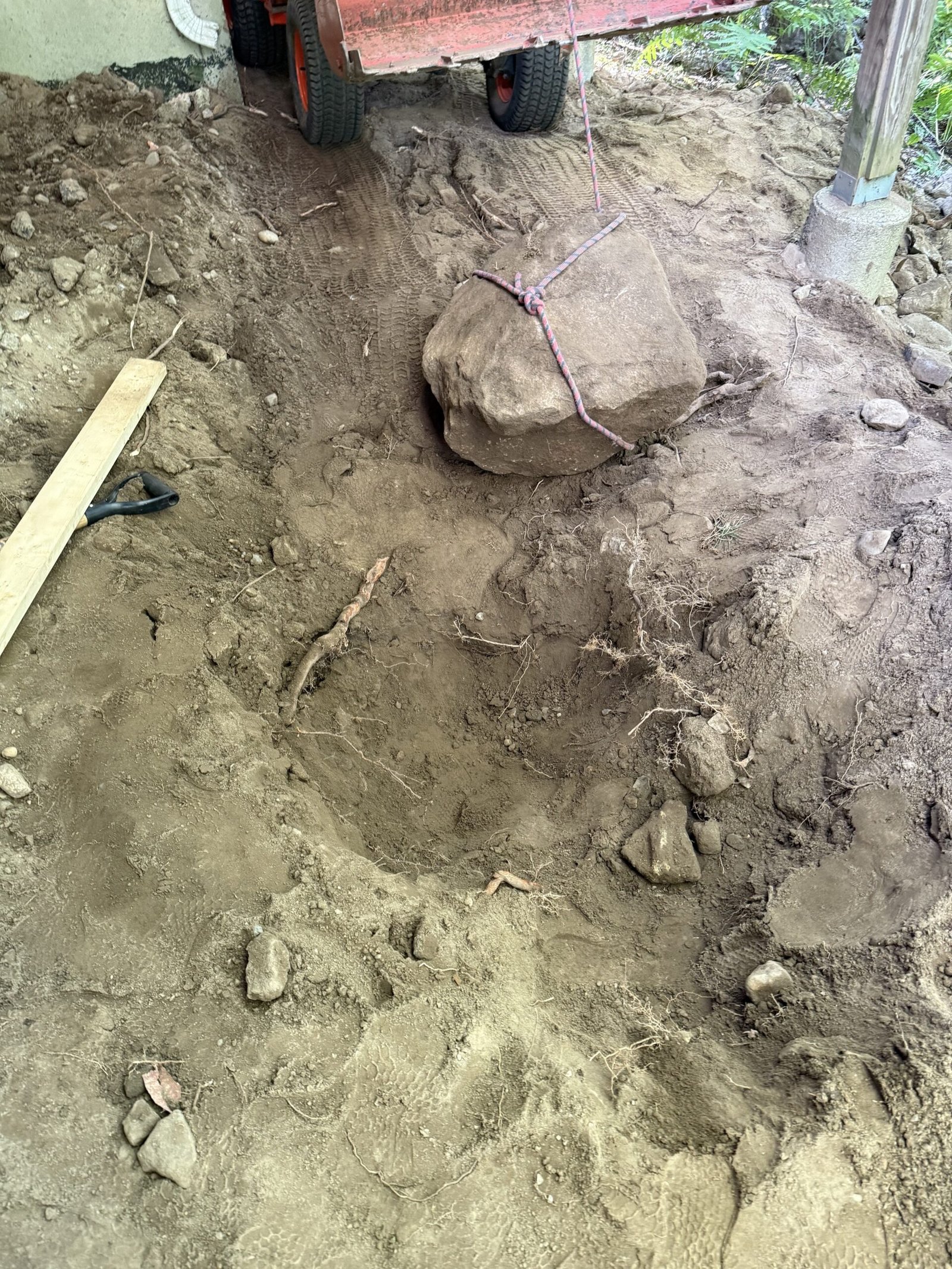 Buried boulder being uncovered during outdoor excavation in Dover Massachusetts