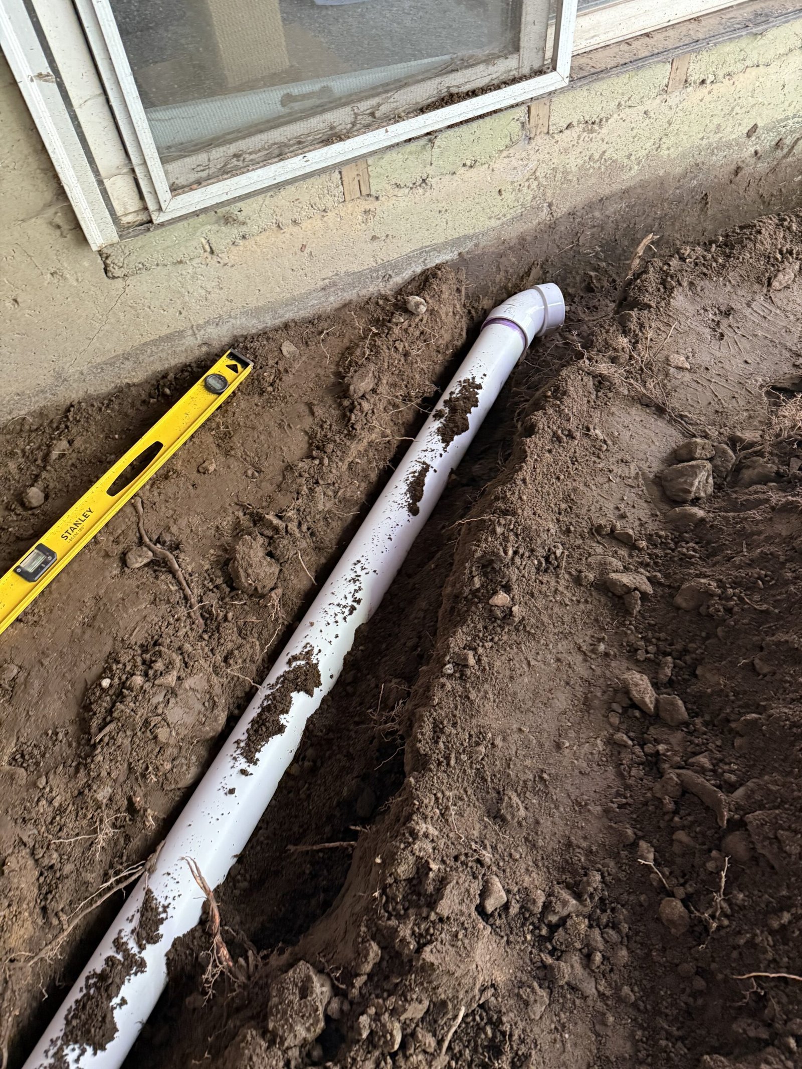 Drainage pipe installed along the house for a Dover patio and walkway project