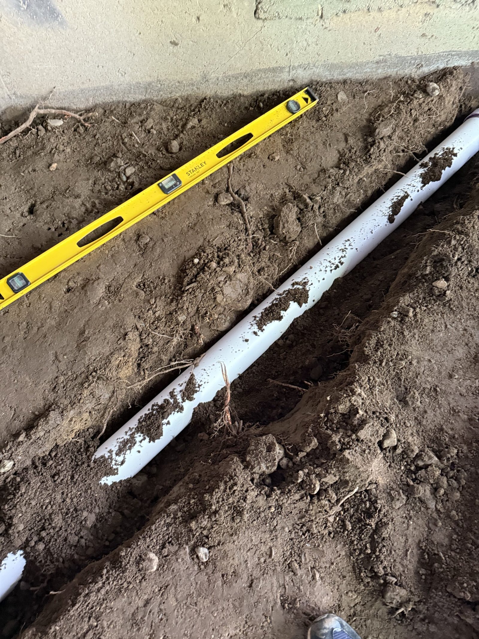 Additional drainage piping installed beside the patio area in Dover Massachusetts