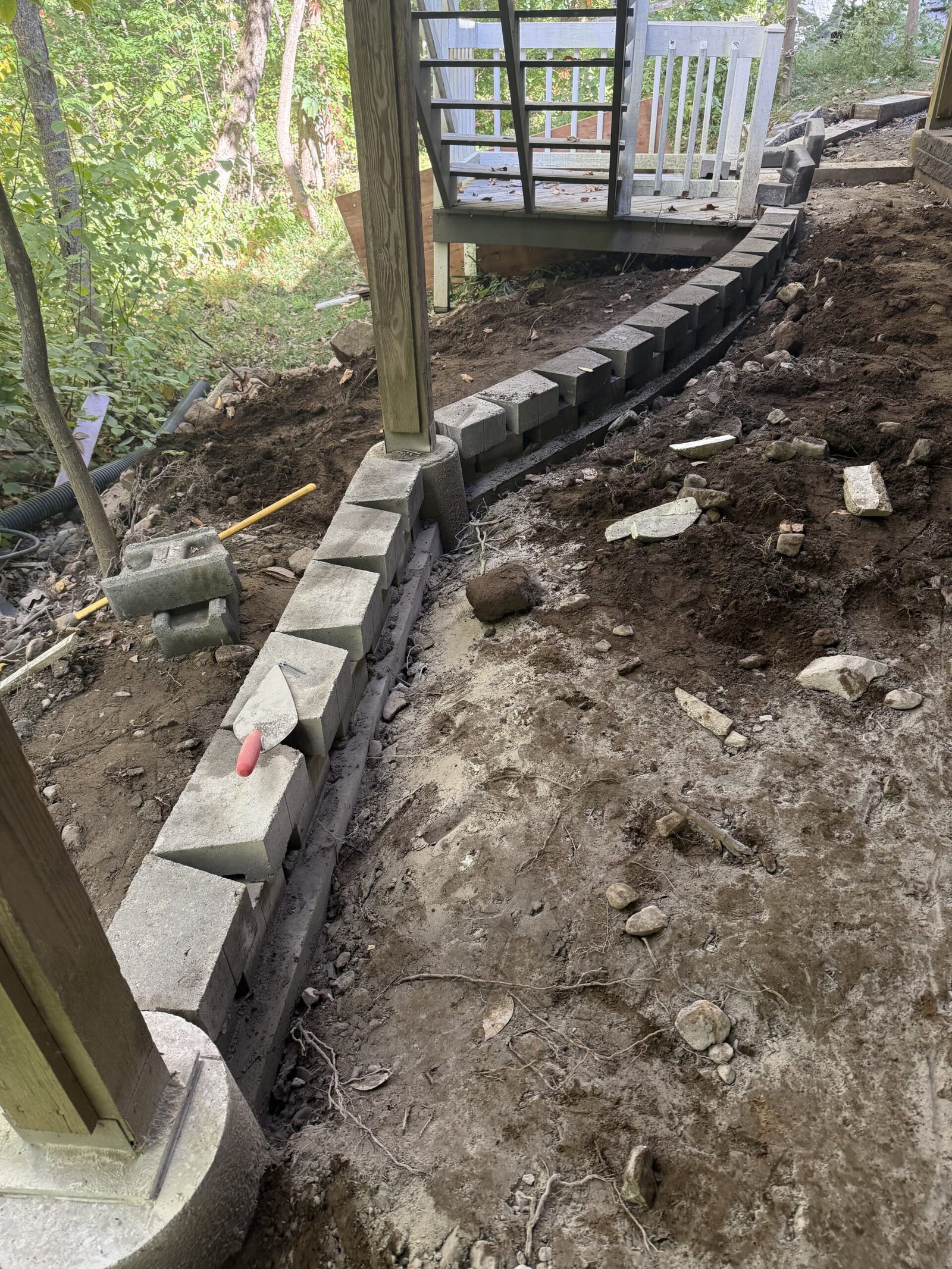 Curved retaining edge under construction beside the Dover patio