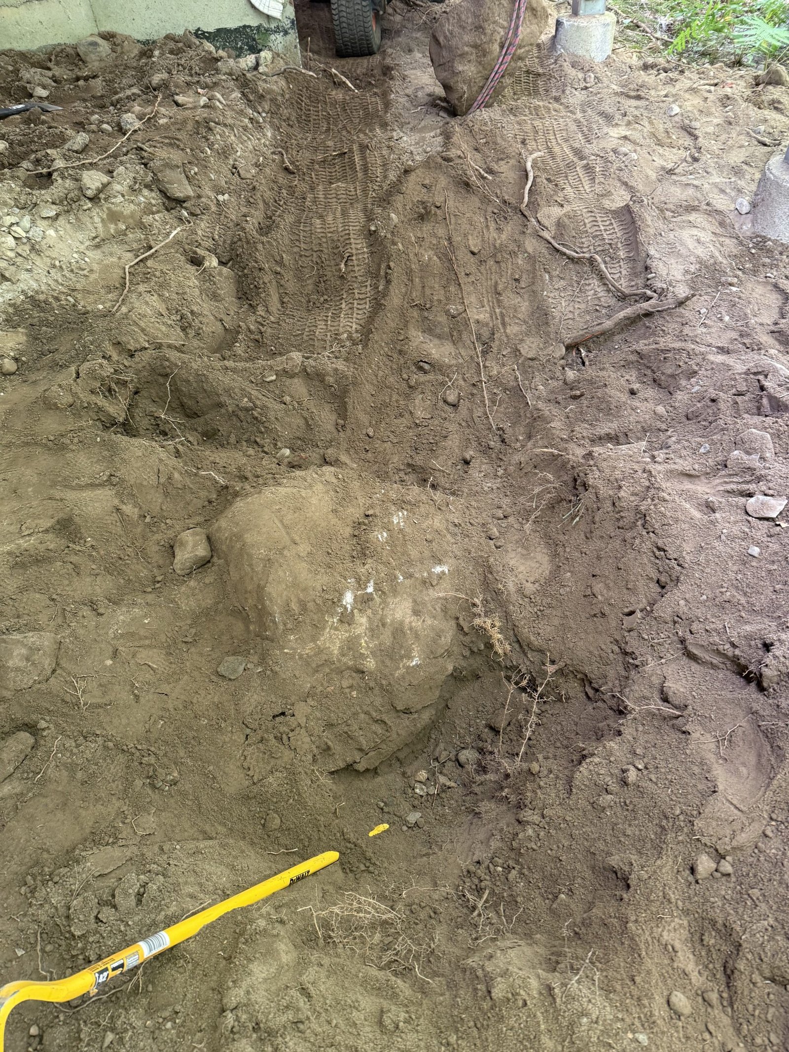 Another large boulder exposed during excavation for a Dover patio project