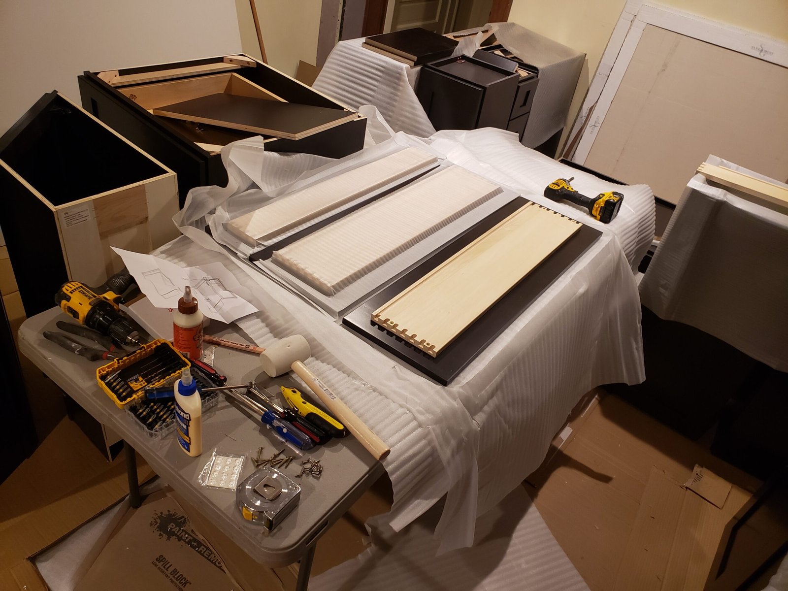 Cabinet components organized for assembly during a Marblehead kitchen remodeling project
