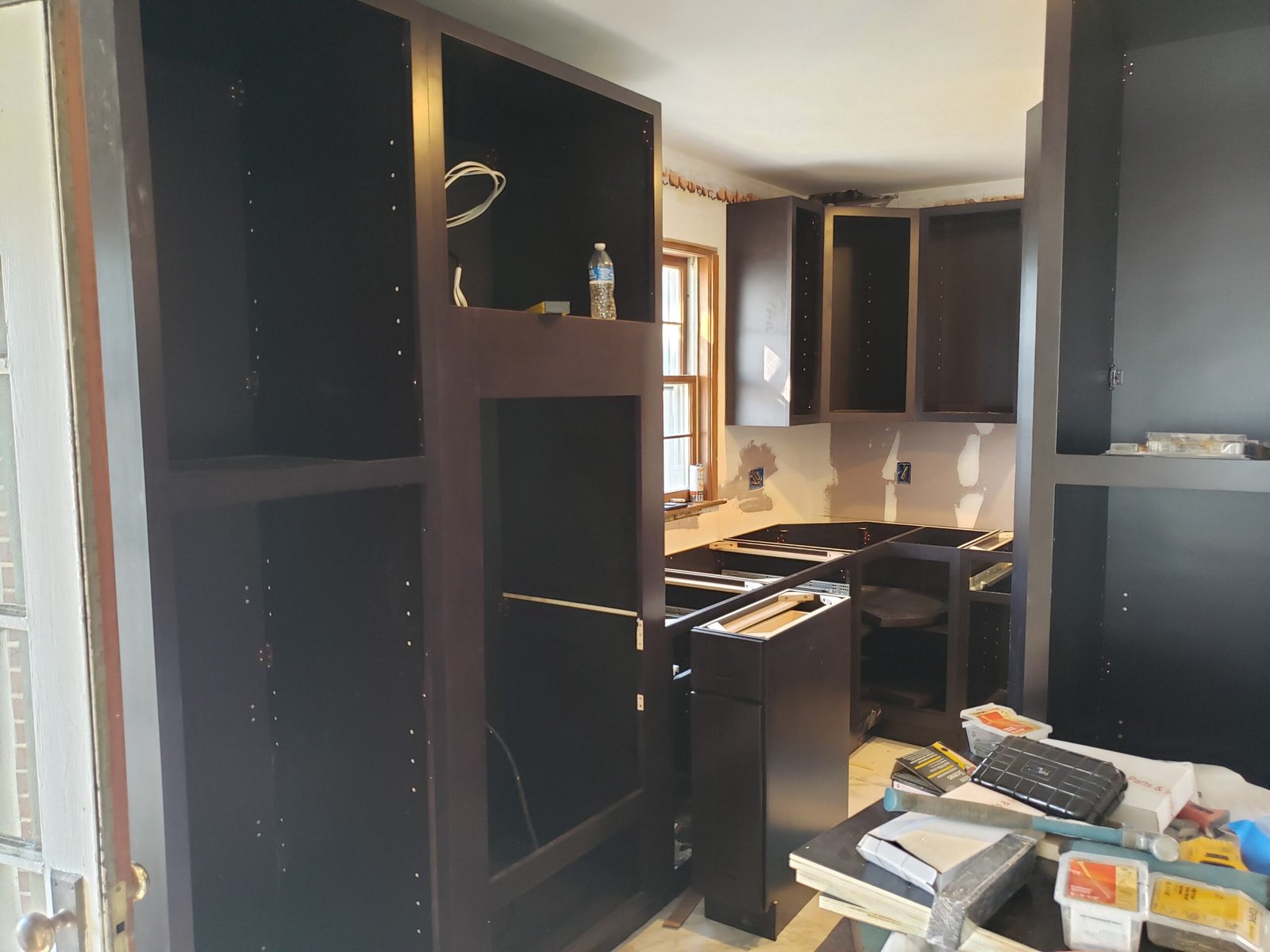 Tall cabinet units being fitted during kitchen installation in Marblehead Massachusetts