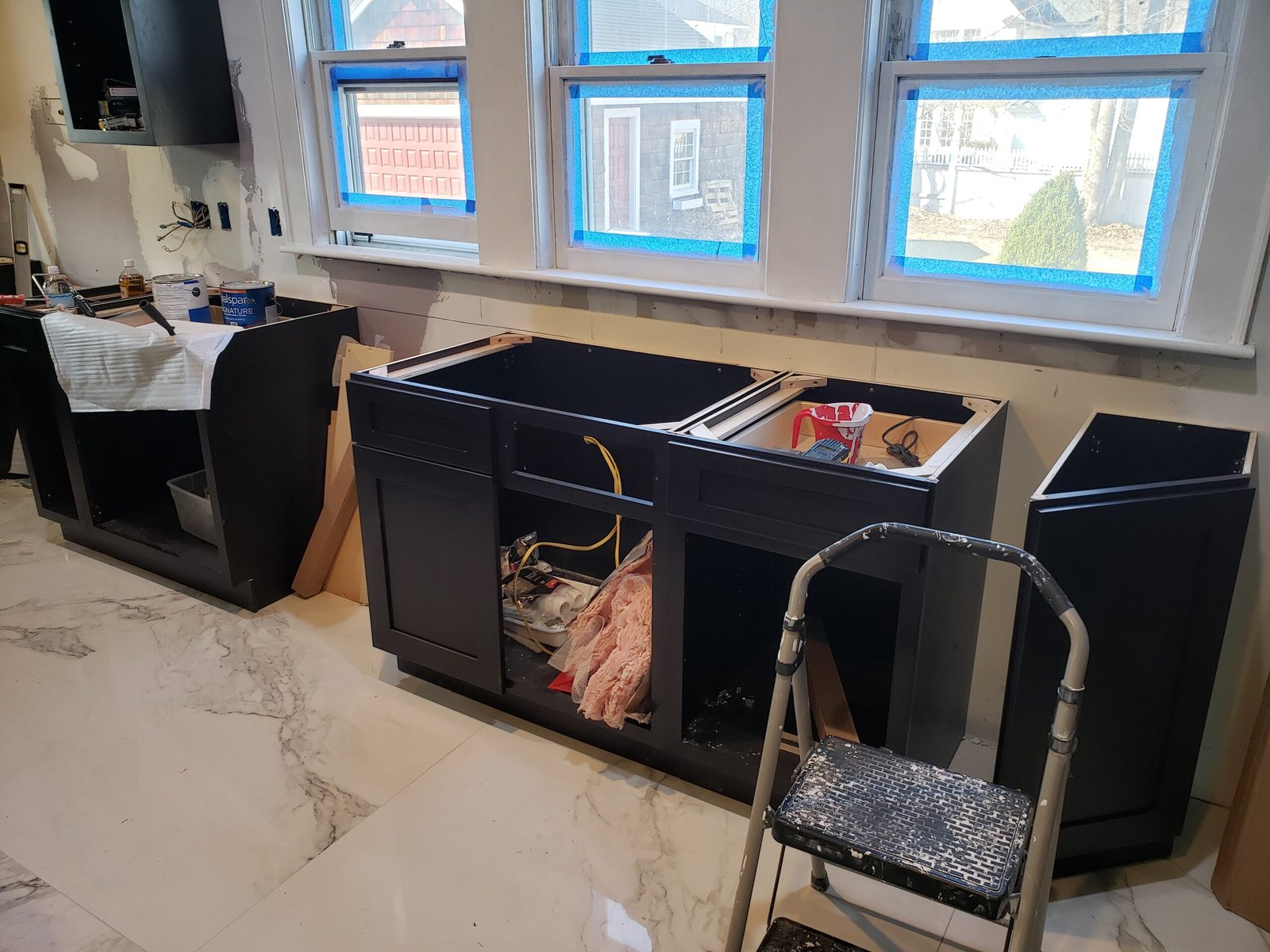 Kitchen island and surrounding cabinets being installed in Marblehead Massachusetts