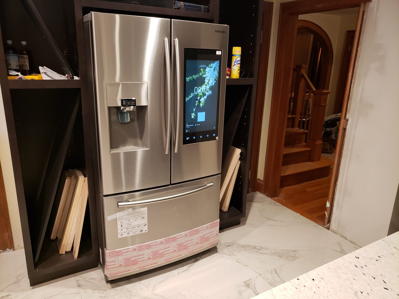 Stainless-steel refrigerator installed within dark kitchen cabinetry in Marblehead Massachusetts