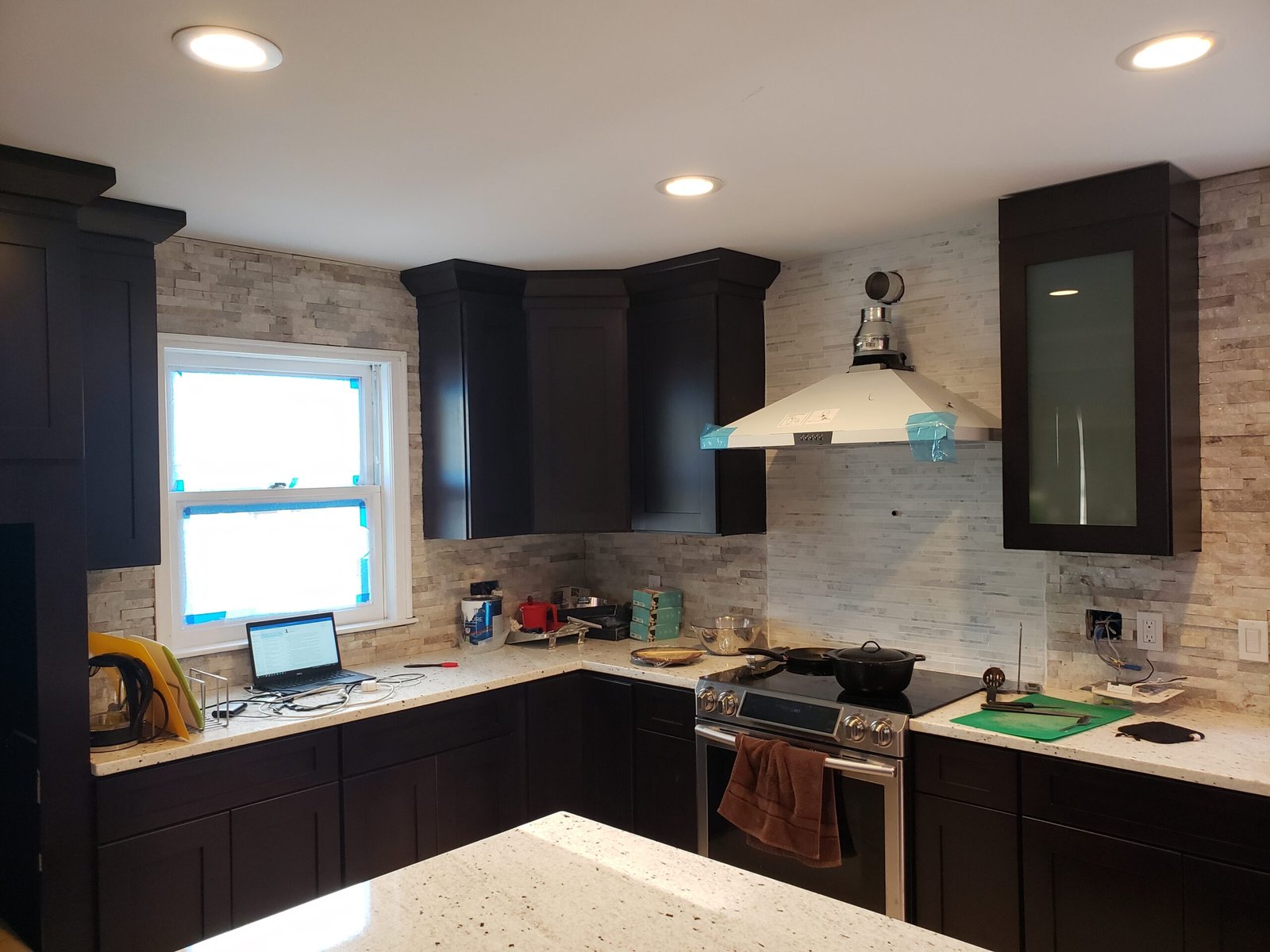 Cooking wall with vent hood cabinets and backsplash during a Marblehead kitchen renovation