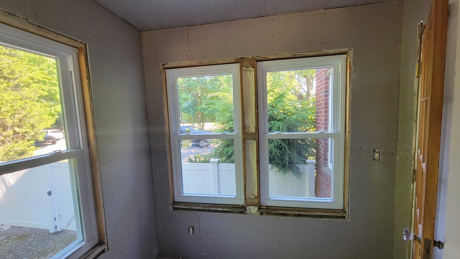 Drywall finishing and new windows before final painting in a Marblehead office