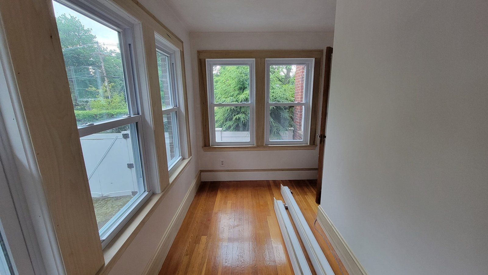 Long view through the completed Marblehead office showing hardwood floor and finished window walls