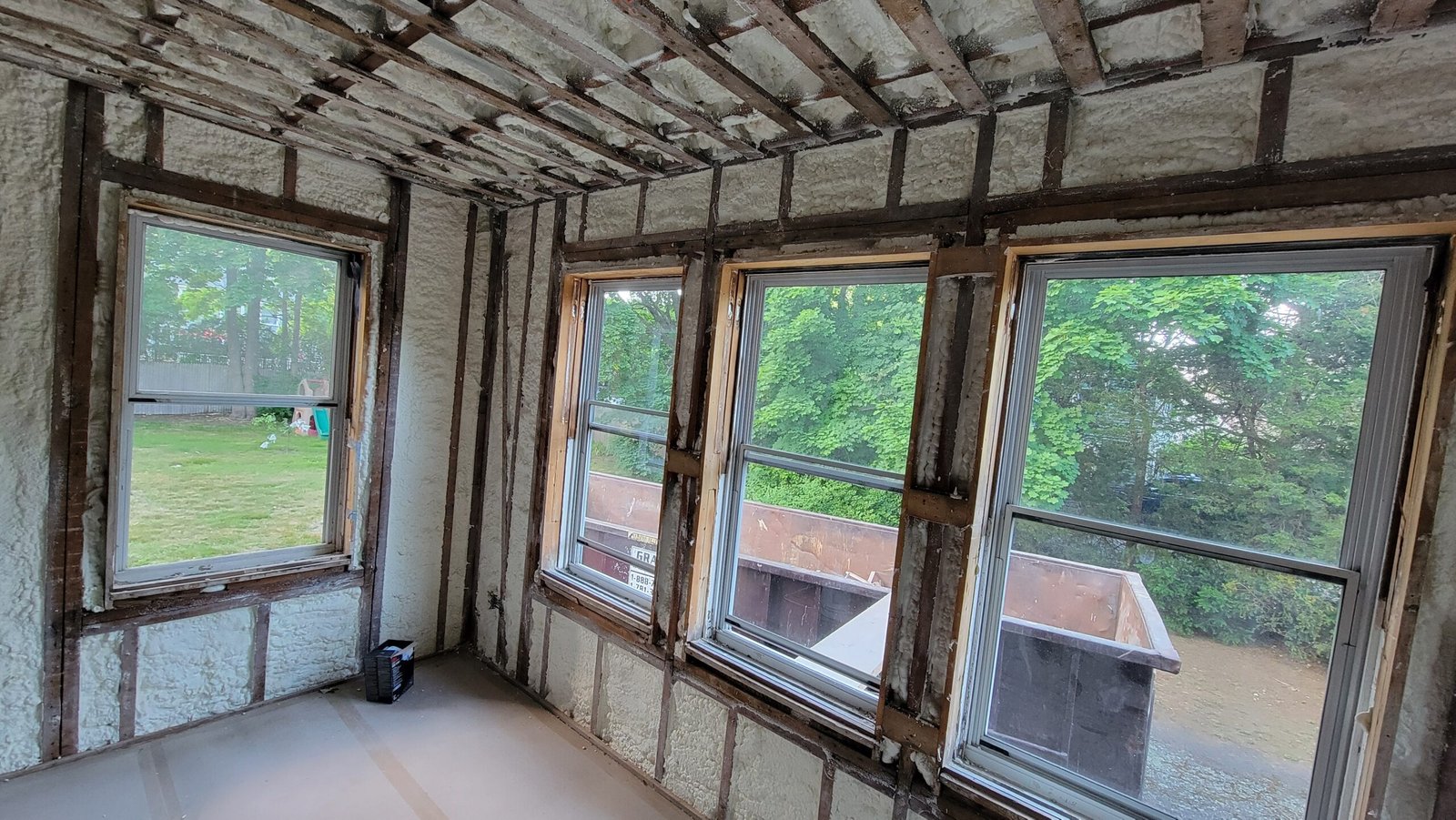 Office walls opened around multiple windows during framing and insulation preparation in Marblehead Massachusetts