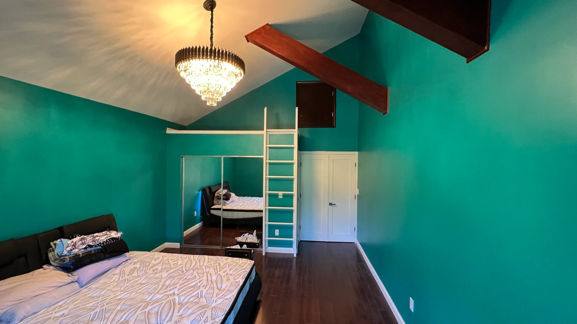 Finished Salem interior with custom built-in shelving, dark hardwood flooring, and decorative ceiling beams