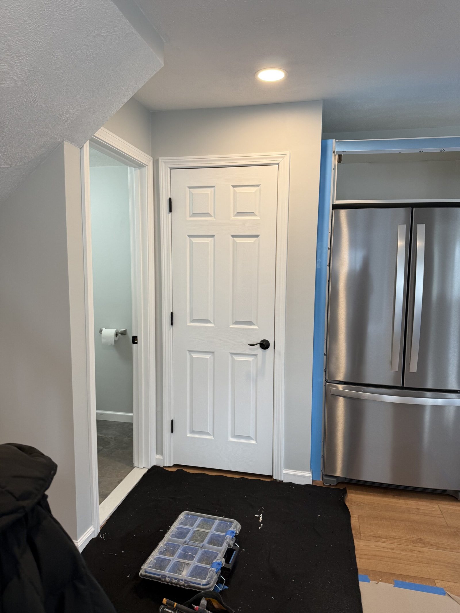Finished white doors trim and refrigerator connection beside a remodeled Salem kitchen