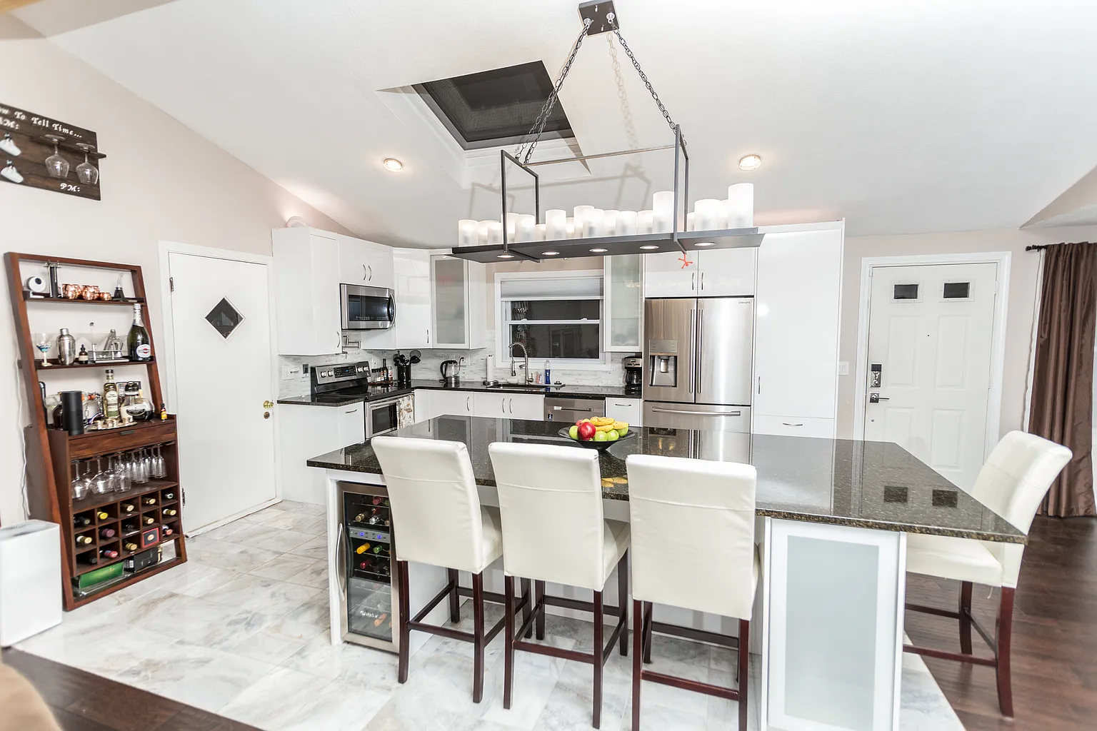 Professionally staged kitchen dining and island area in a Saugus whole-house renovation