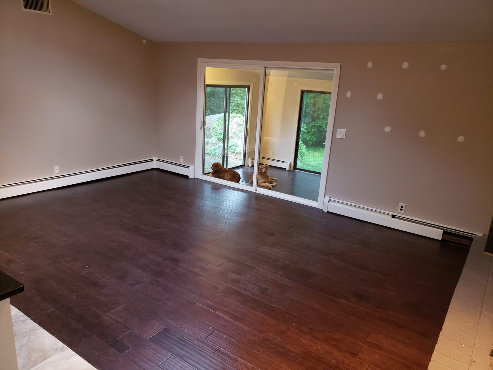 Completed empty room with engineered hardwood flooring after a Saugus whole-house renovation