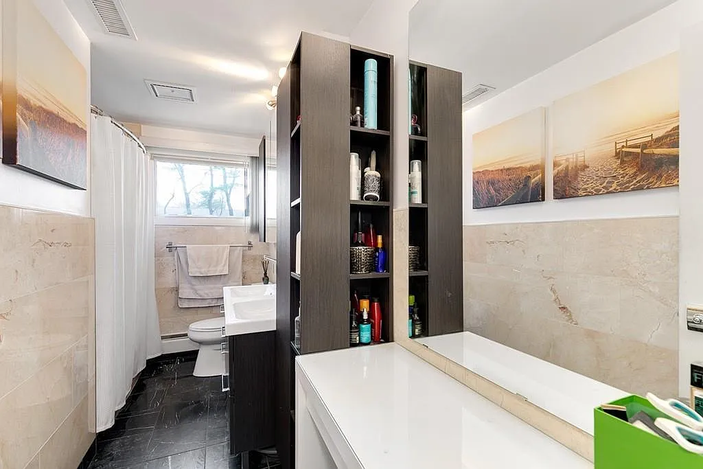Staged kitchen storage wall island and open living connection in a Saugus renovation