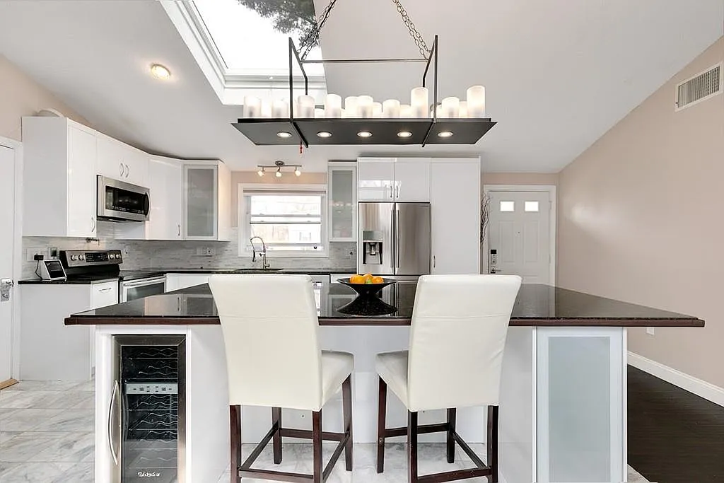 Professionally staged white kitchen and island after a Saugus Massachusetts home renovation