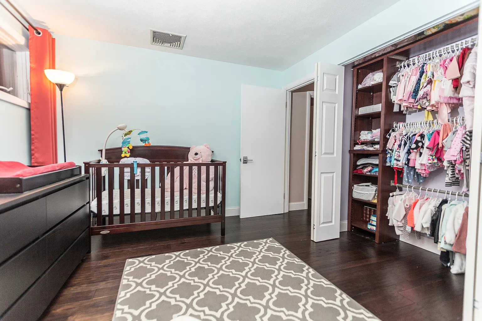 Professionally staged bedroom with new windows dark engineered hardwood and white trim in Saugus