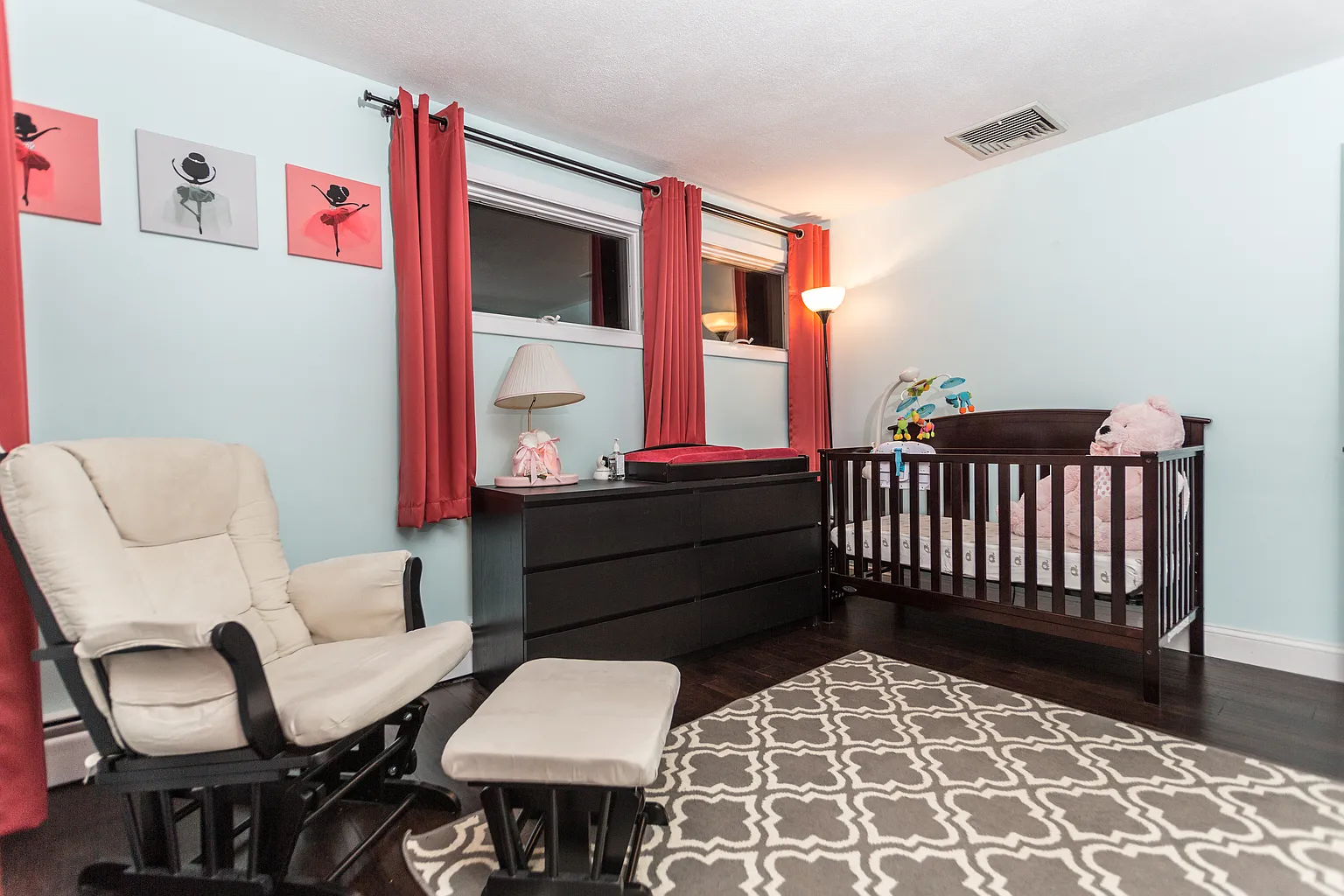 Second staged view of a completed Saugus bedroom with hardwood flooring and larger windows