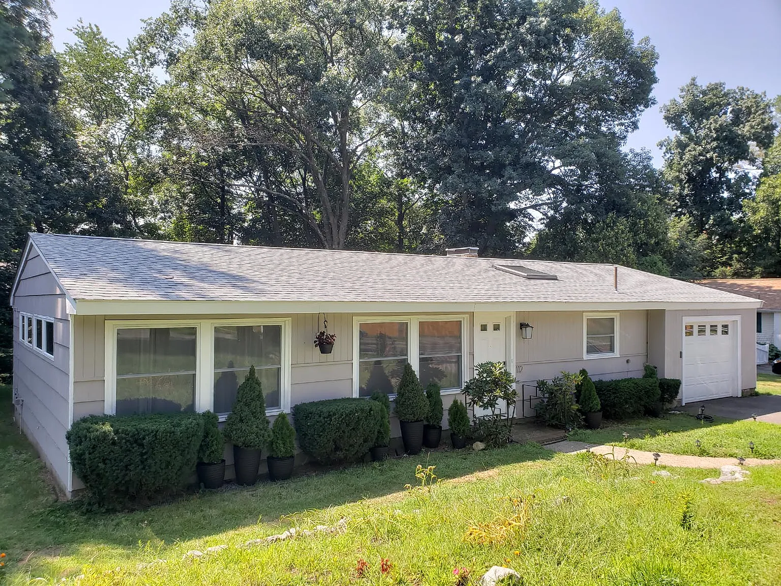 Finished exterior of a renovated Saugus Massachusetts home with refreshed paint and landscaping