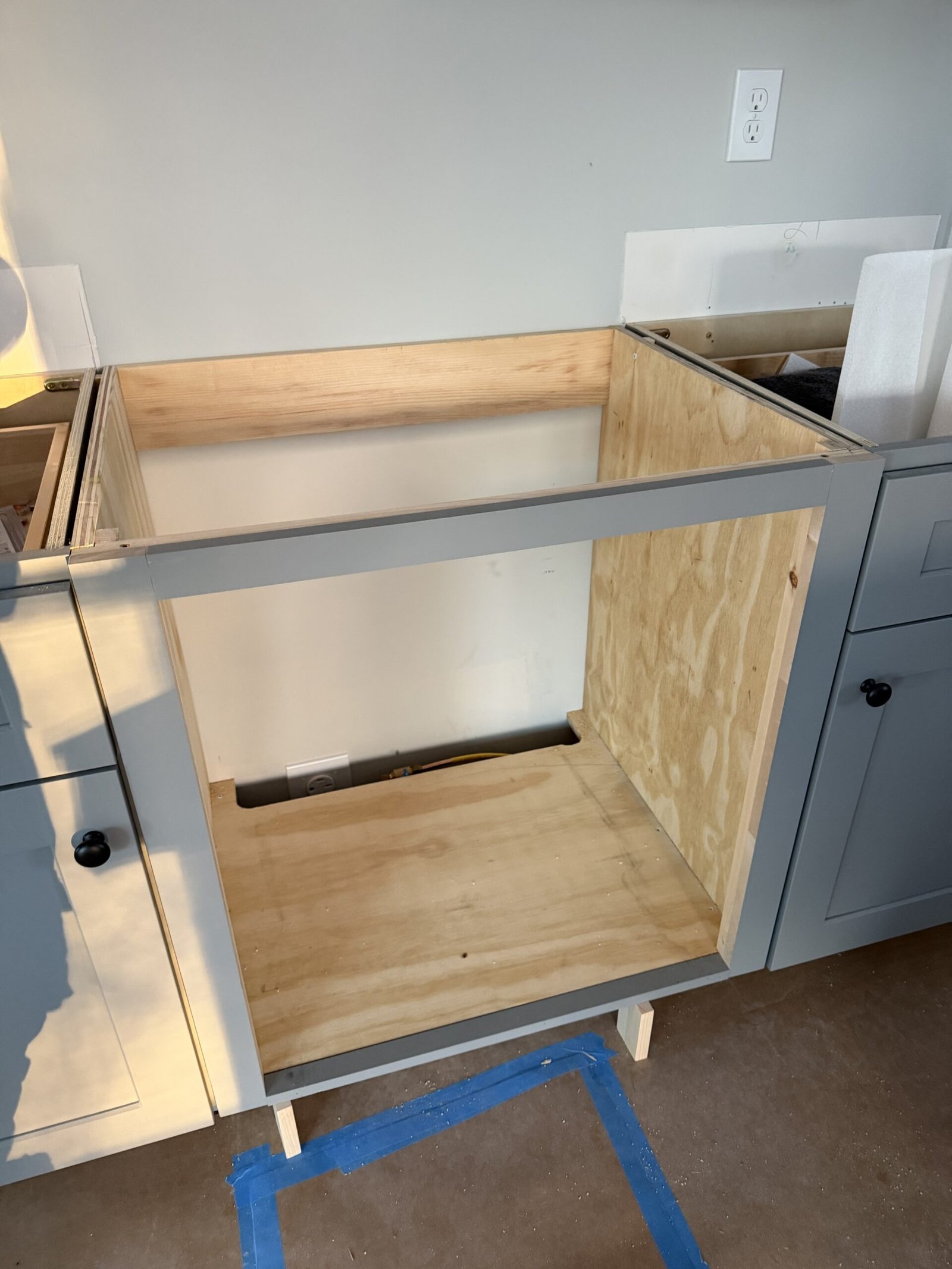 Completed custom cabinet opening prepared to receive a built-in oven in Uxbridge Massachusetts
