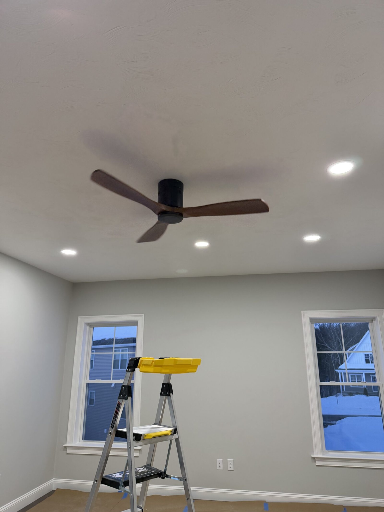 Completed Uxbridge room with recessed lighting and a modern ceiling fan after electrical upgrades