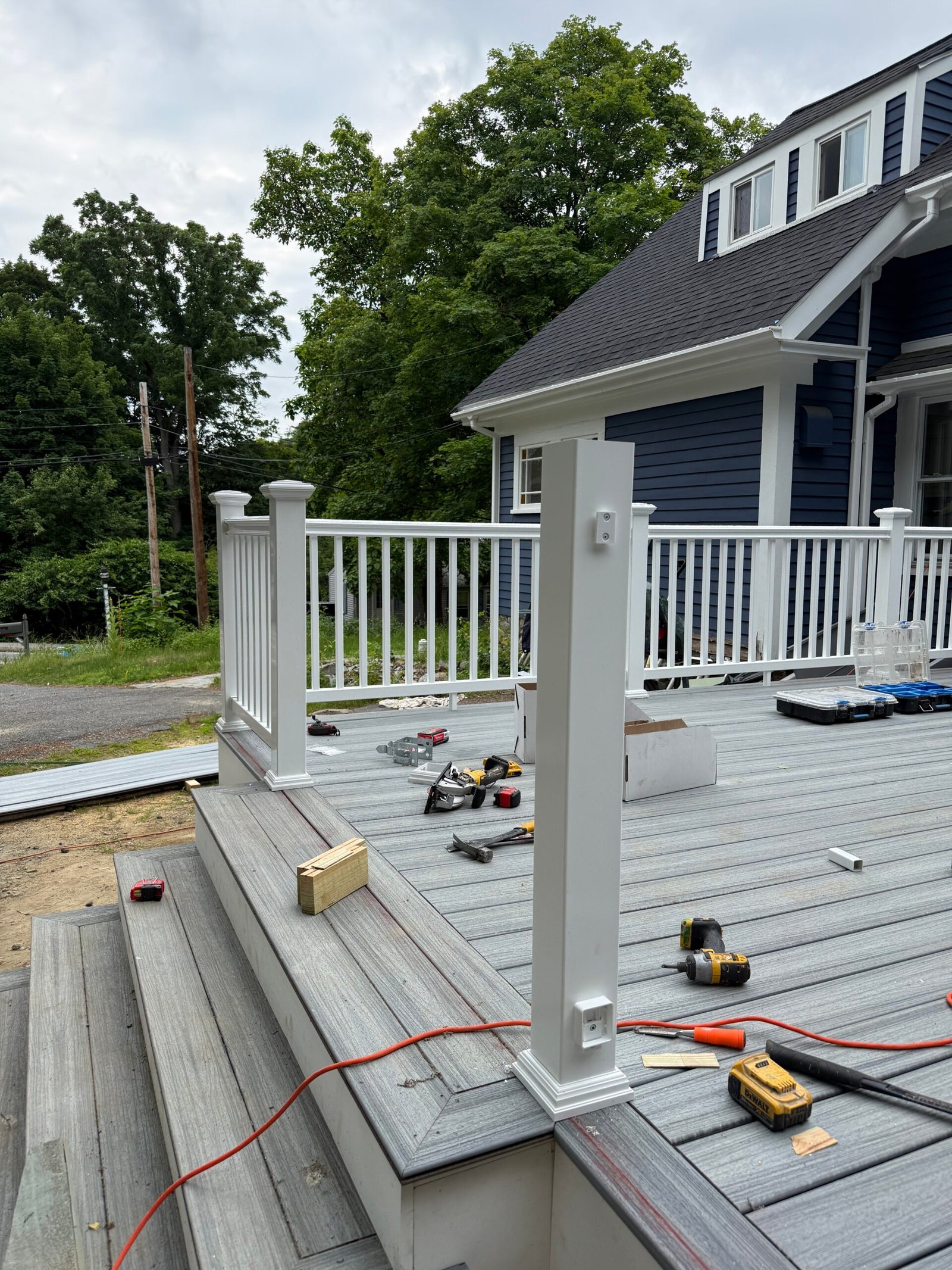 Railing installation during a deck construction project in Wayland Massachusetts, photograph 7