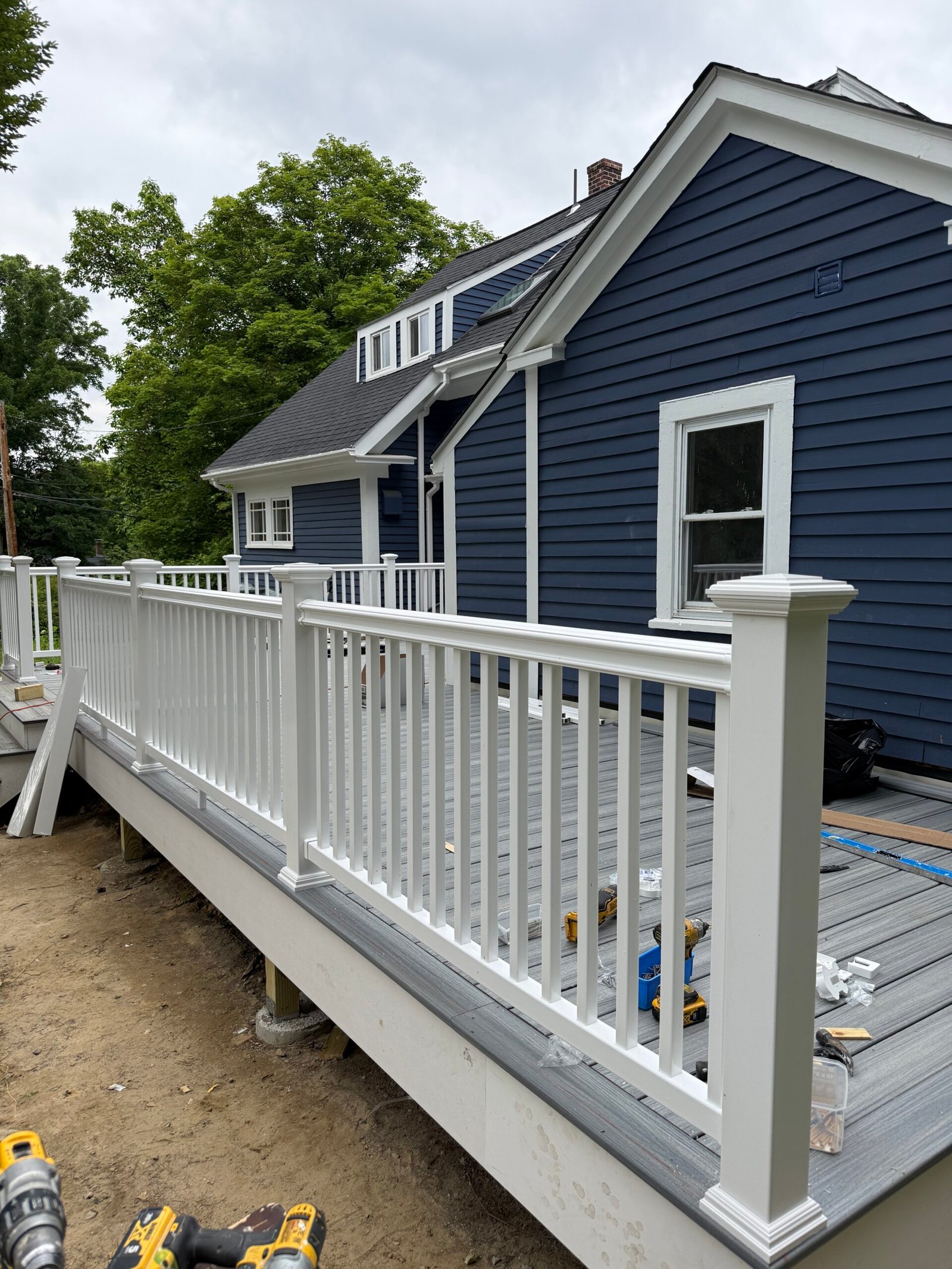 Railing installation during a deck construction project in Wayland Massachusetts, photograph 13