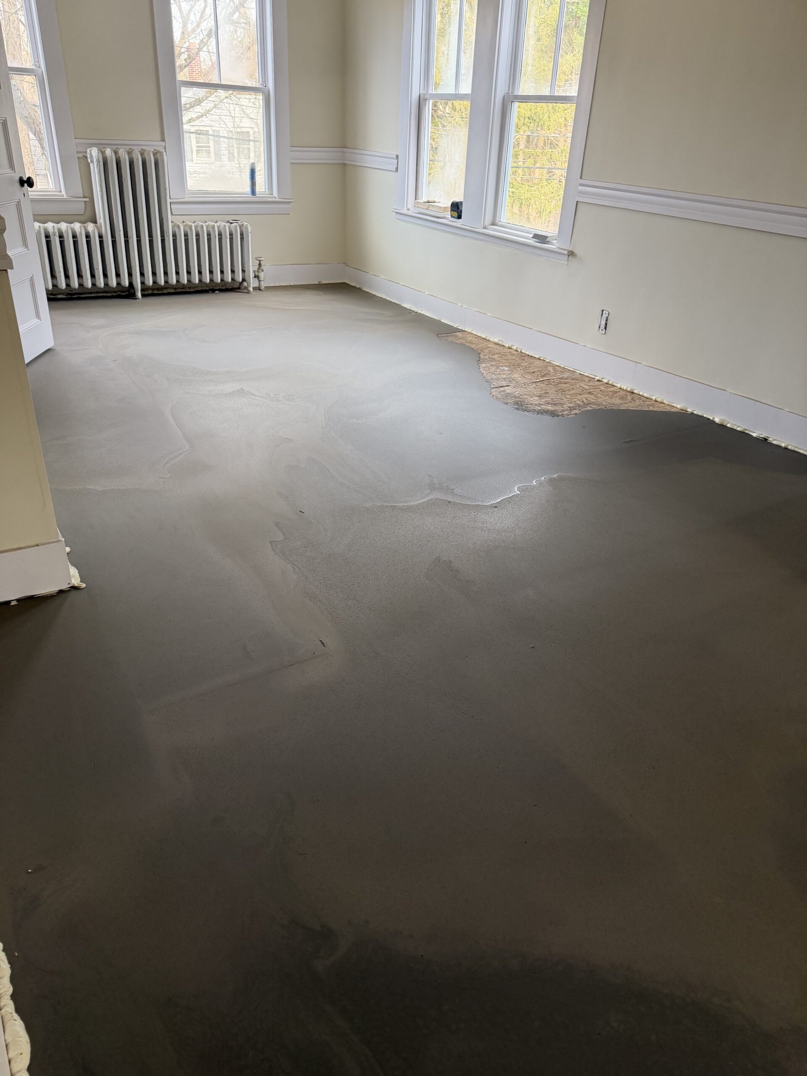 Self-leveling compound and floor preparation during whole-house renovation in Wayland Massachusetts