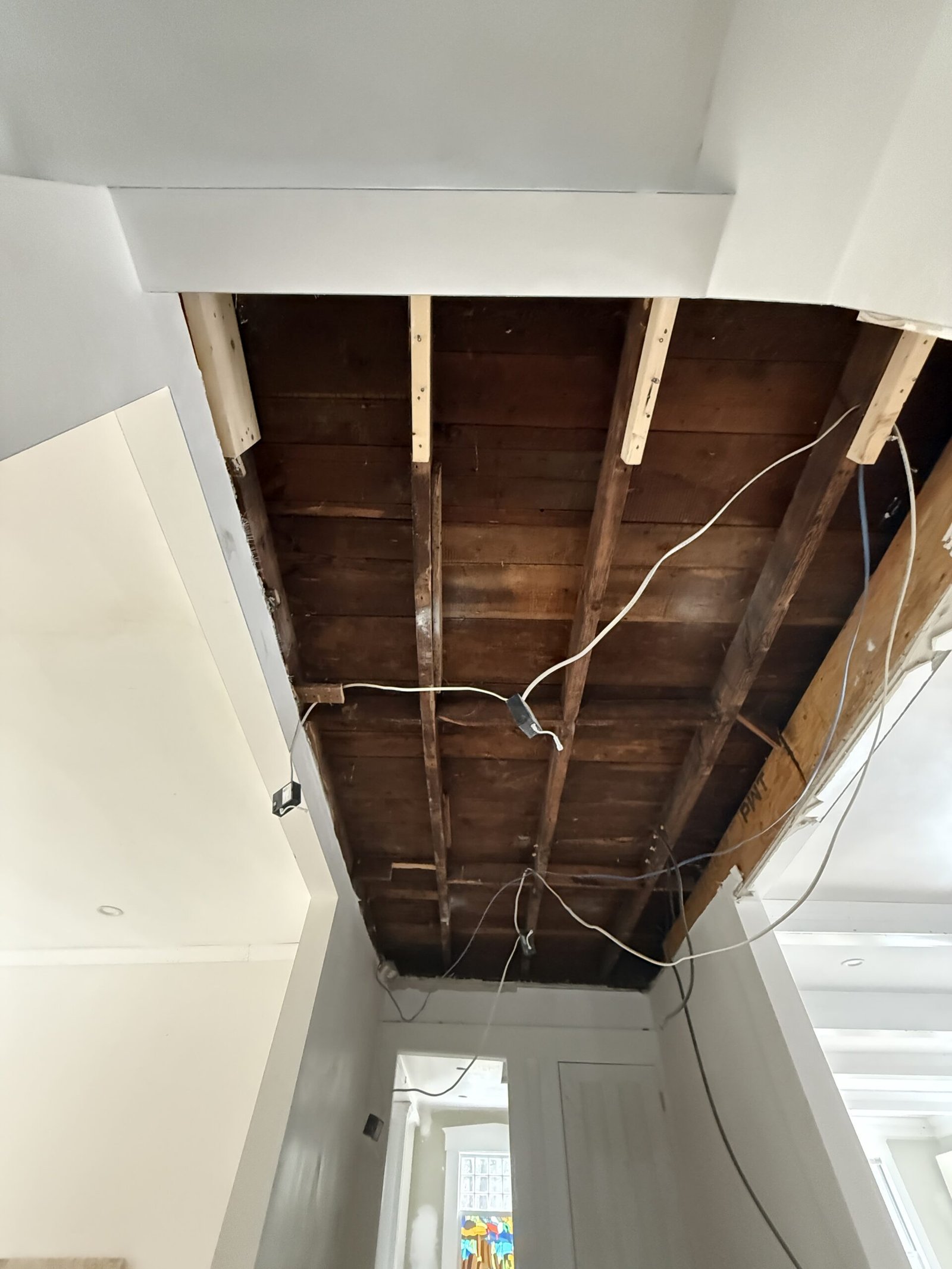 Open ceiling, wall repair, or drywall work during whole-house renovation in Wayland Massachusetts, photograph 1