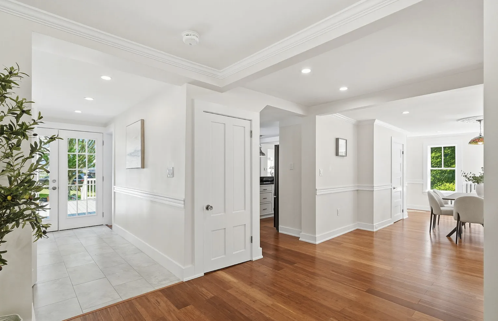 Professionally staged entry staircase and open-plan interior after renovation in Wayland Massachusetts — view 2