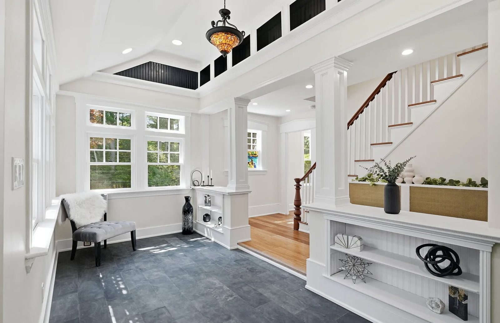 Professionally staged entry staircase and open-plan interior after renovation in Wayland Massachusetts — view 1