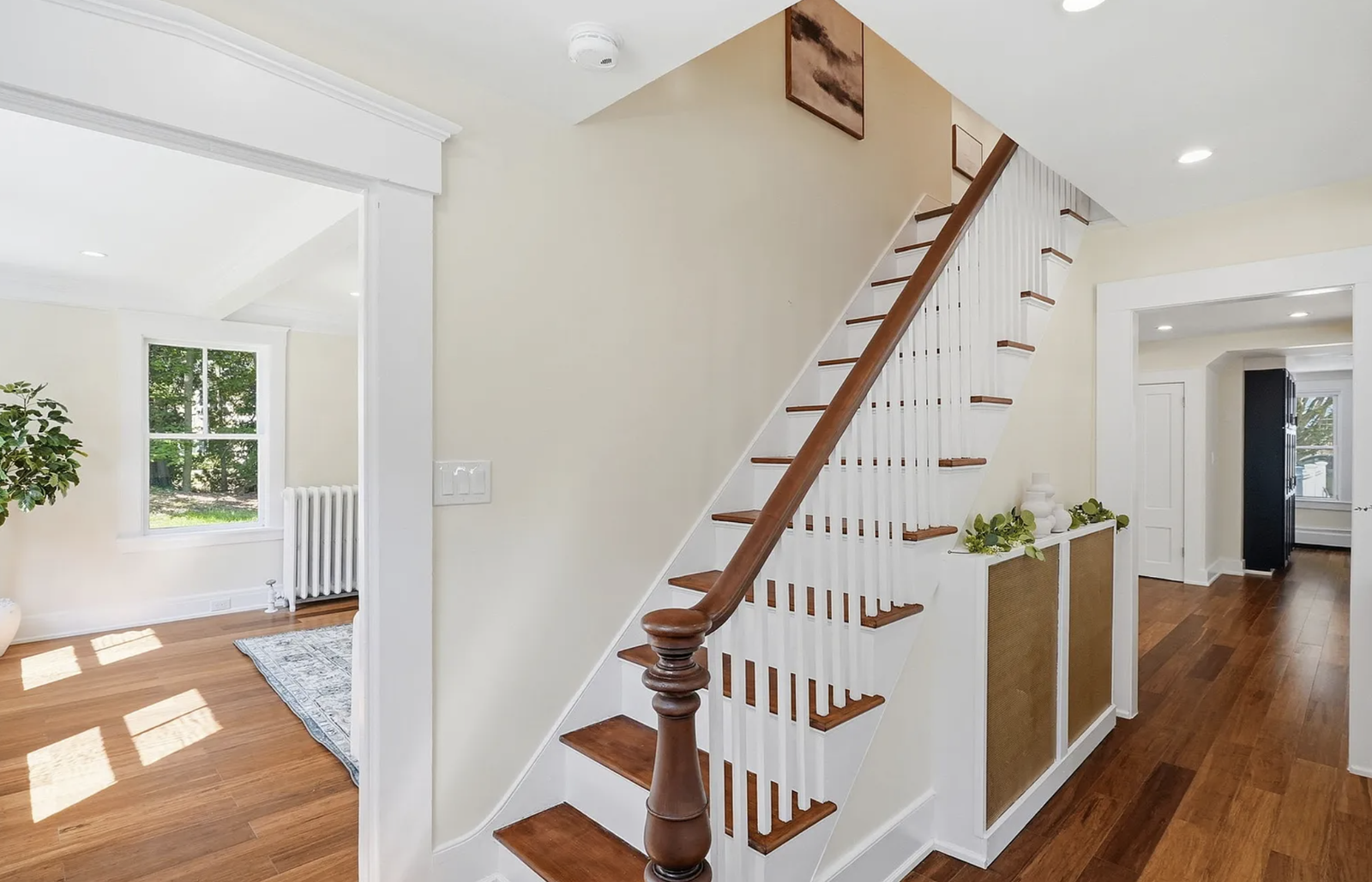 Professionally staged entry staircase and open-plan interior after renovation in Wayland Massachusetts — view 4