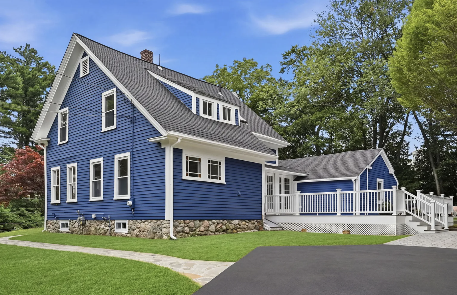 Professionally staged exterior and completed deck after whole-house renovation in Wayland Massachusetts — view 2