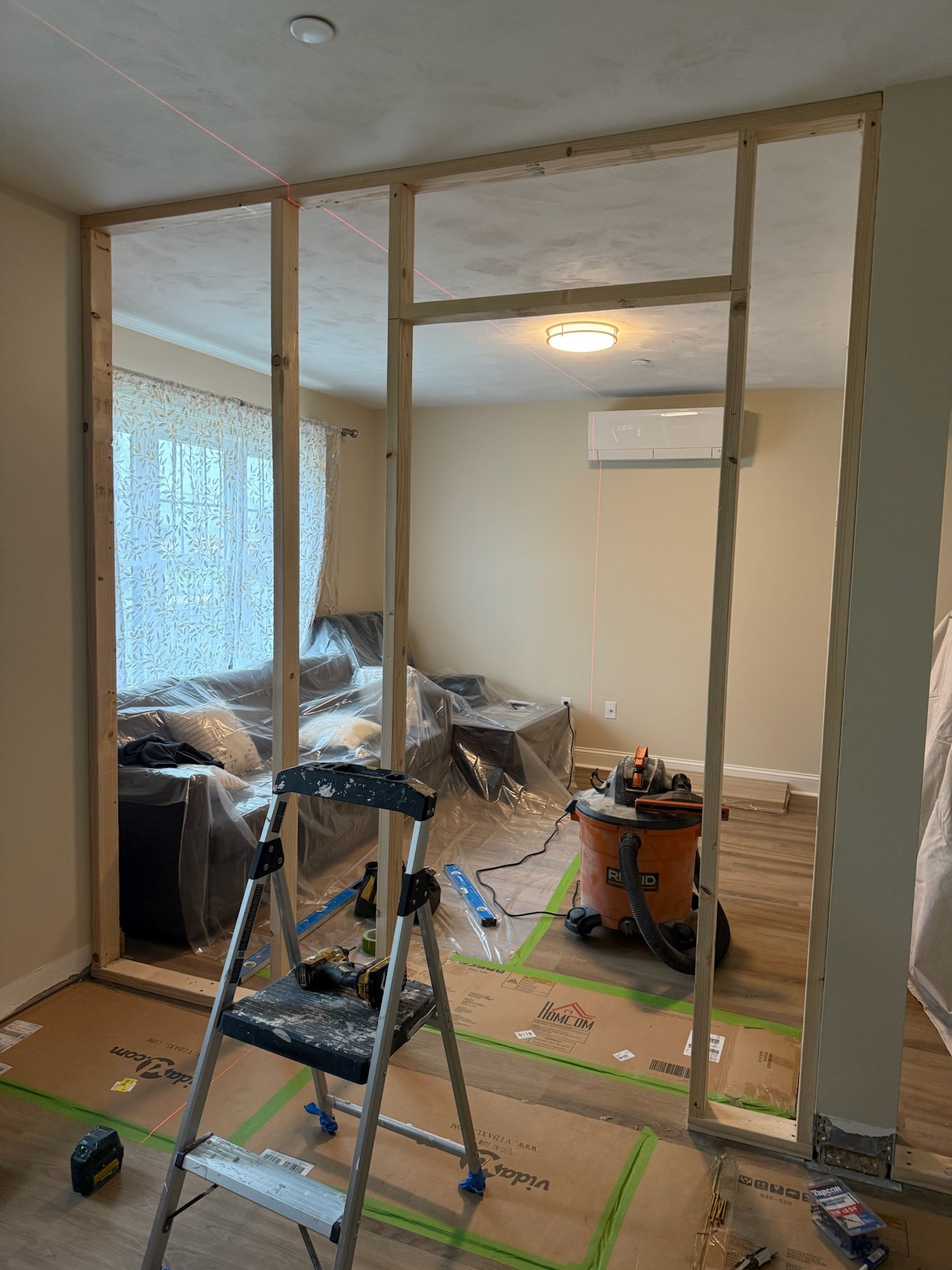 Initial layout and framing preparation for guest bedroom conversion in Wilmington Massachusetts