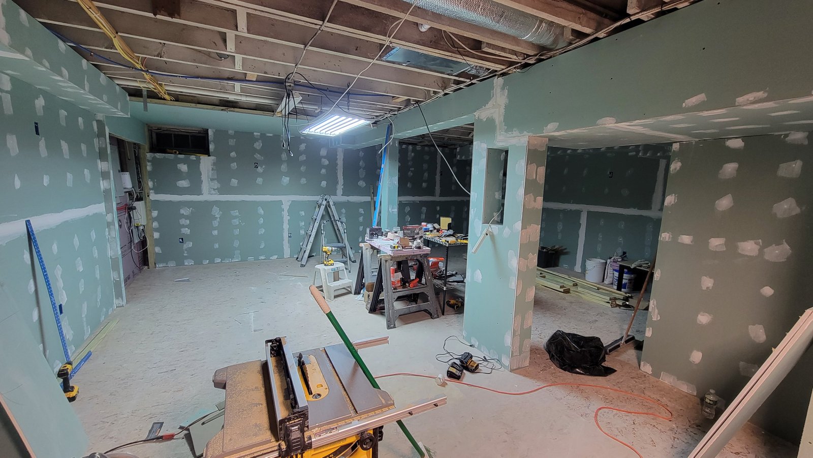 Drywall panels installed over the framed and insulated basement walls in Marblehead Massachusetts