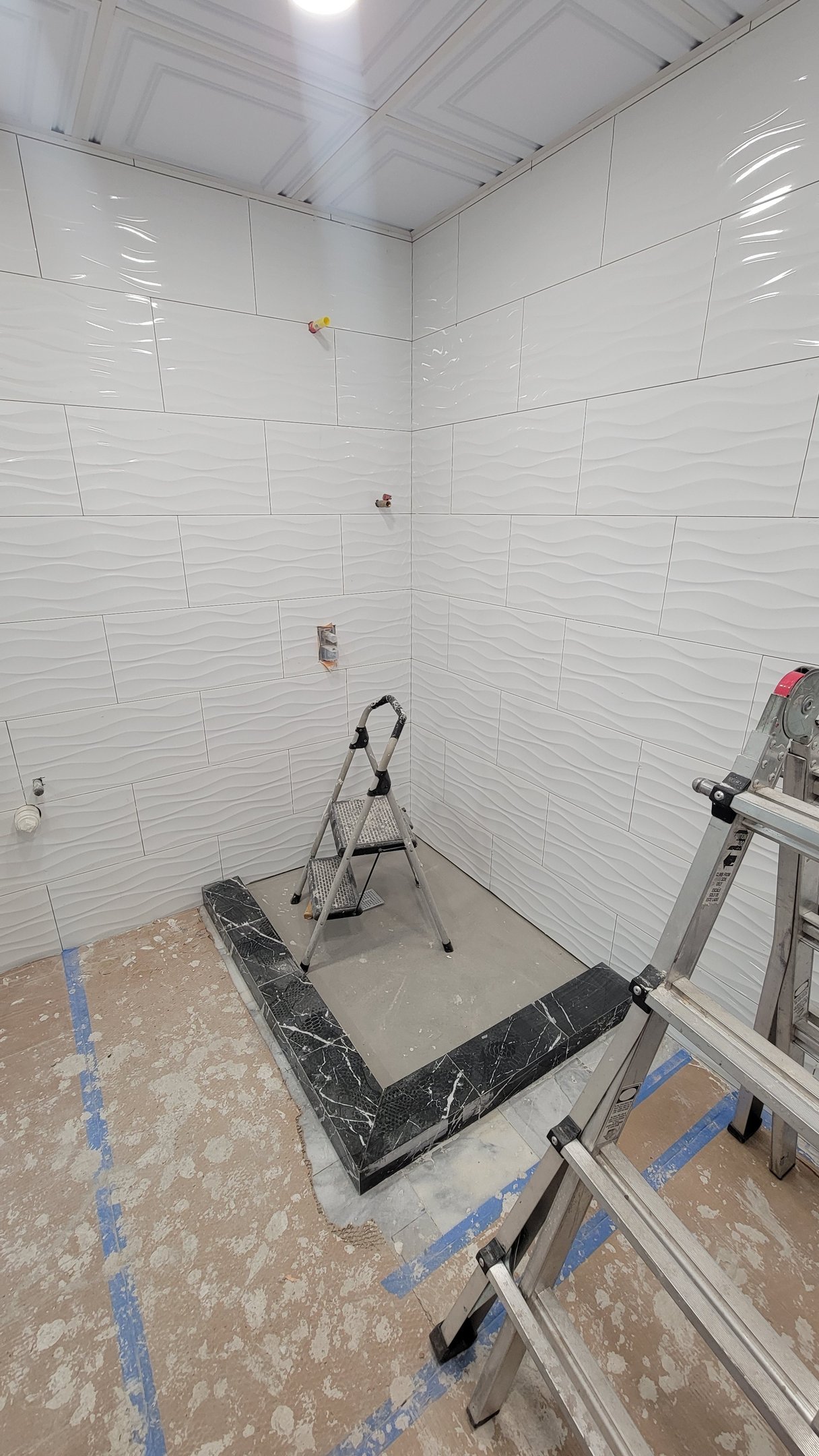 Bathroom wall tile installation progressing in Marblehead Massachusetts